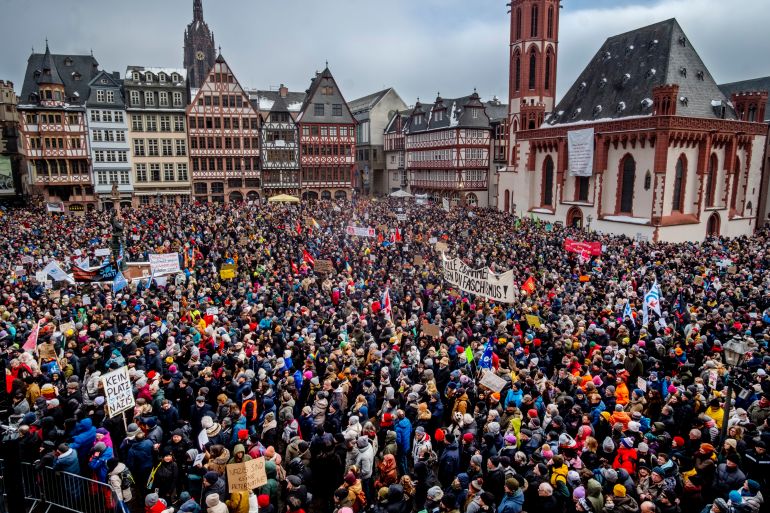 People gather as they protest against the AfD party and right-wing extremism in Frankfurt/Main, Germany, Saturday, Jan. 20