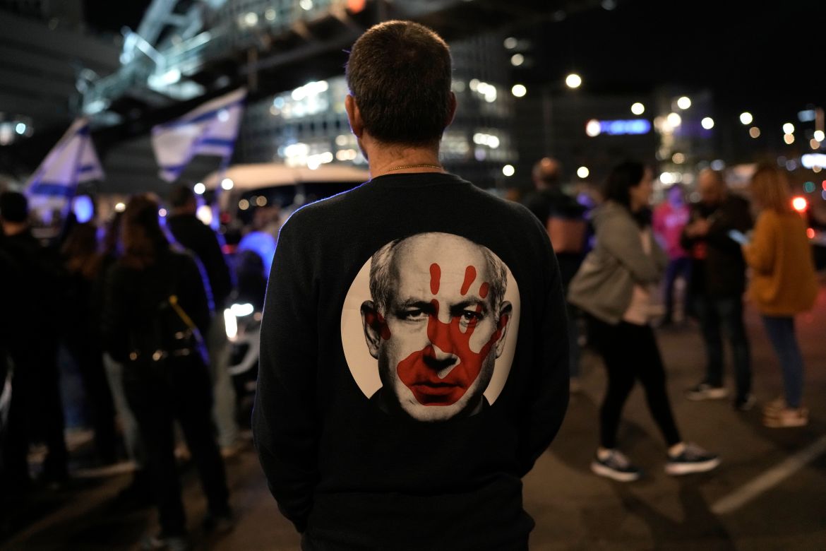 A protester wears a shirt depicting Israeli Prime Minister Benjamin Netanyahu attempt during a demonstration to demand the release of the hostages taken by Hamas militants into the Gaza Strip