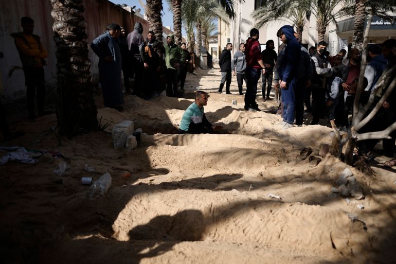 Palestinians dig graves to bury their relatives who were killed in the Israeli bombardment of the Gaza Strip, at the Nasser hospital in Khan Younis, Southern Gaza Strip, Monday, Jan. 22, 2024. (AP Photo/Mohammed Dahman)