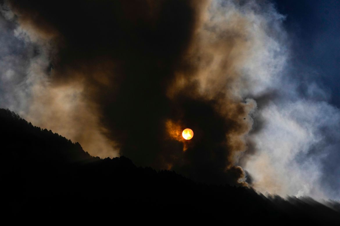 The sun rises during a forest fire on El Cable Hill in Bogota