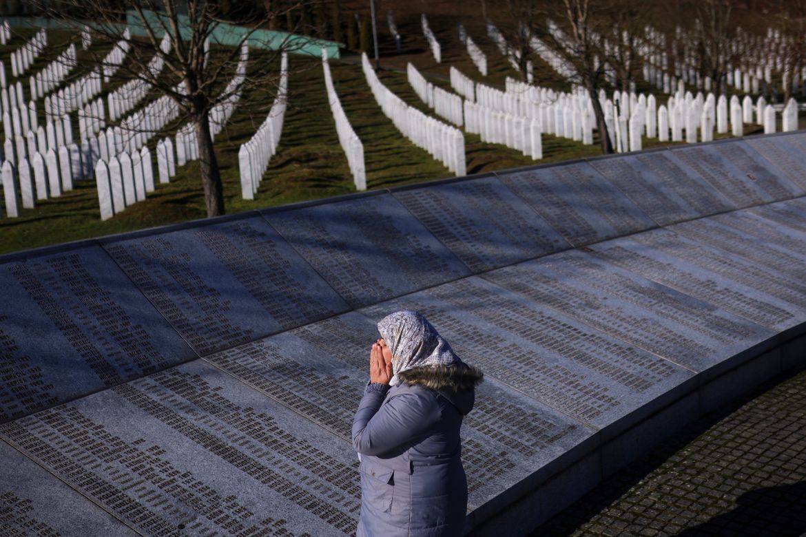 A Bosnian Muslim woman prays next to the monument with names of those killed in the Srebrenica genocide, at the Srebrenica Memorial Center, on International Holocaust Remembrance Day, in Potocari, Bosnia, Saturday, Jan. 27