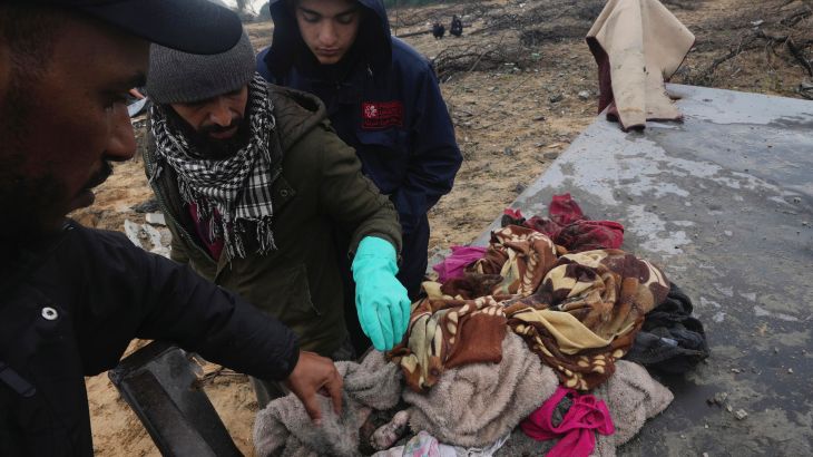 Palestinians collect bodies after an Israeli strike in Zuweida, Gaza Strip.
