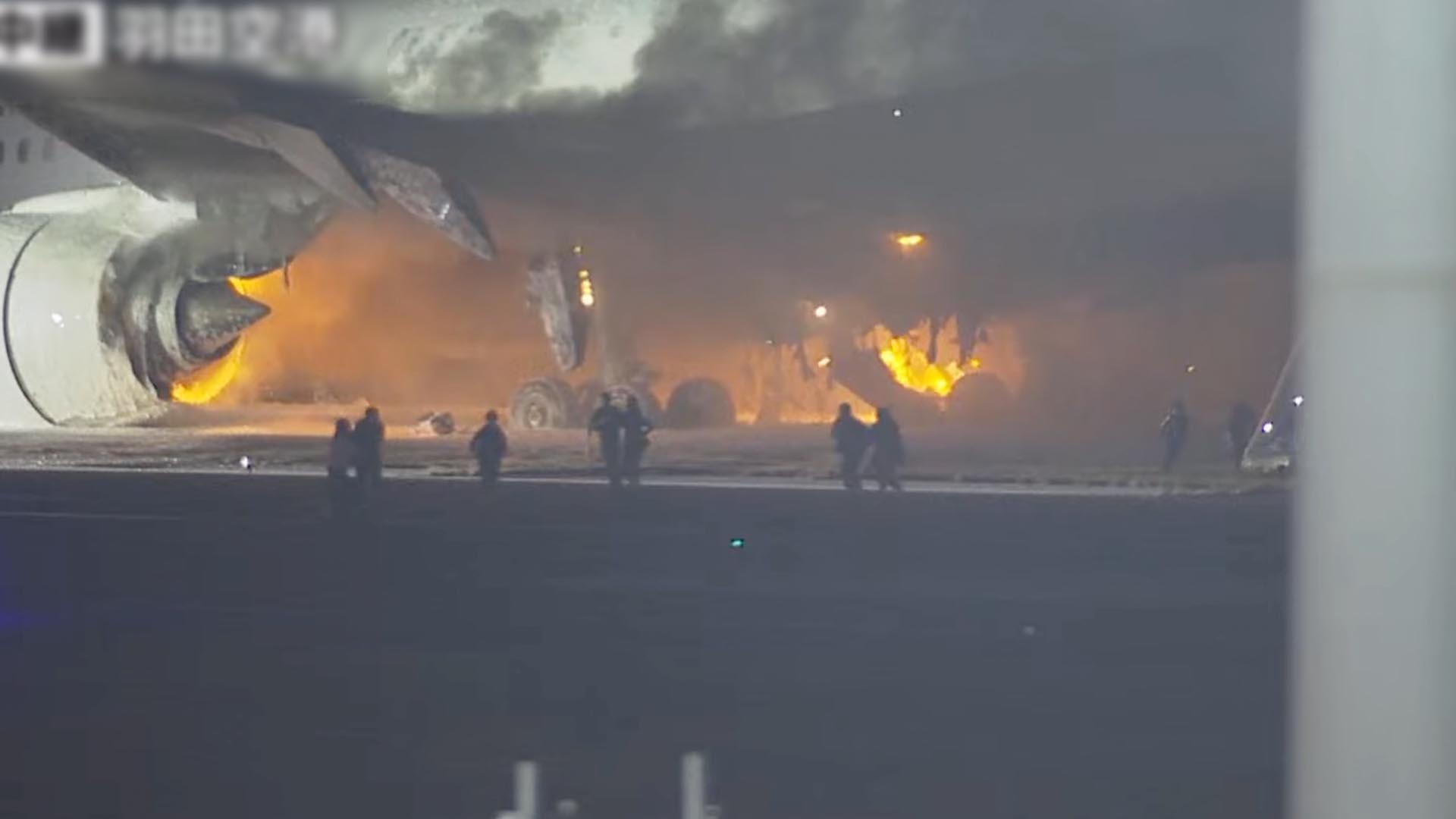 People flee burning plane at Tokyo airport | Aviation