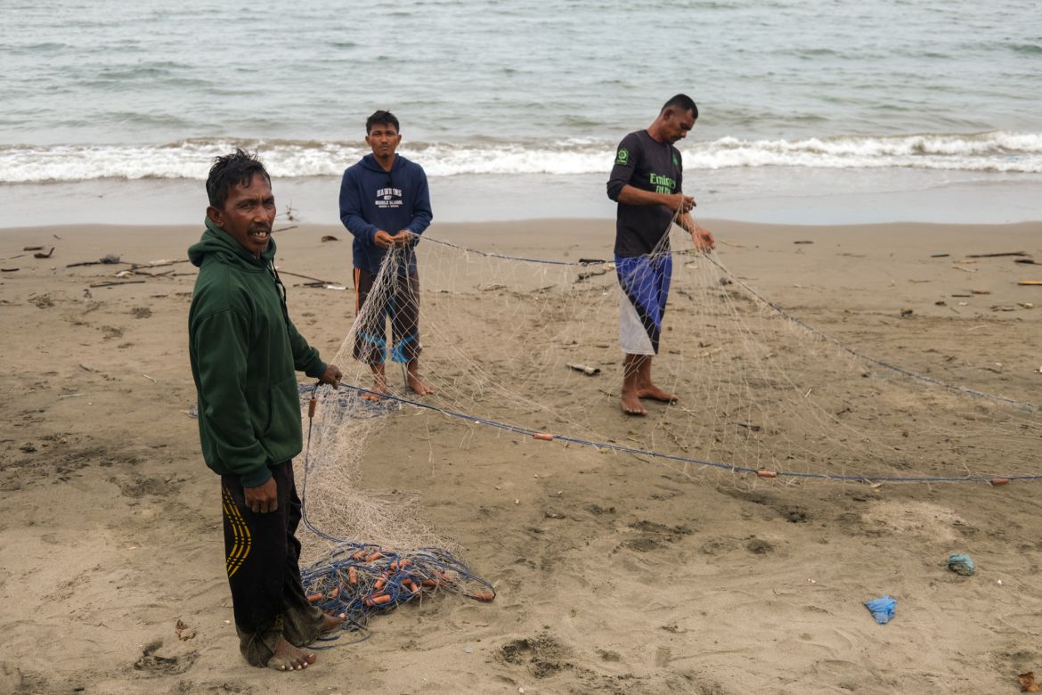 These fishermen live in a village, on the same beach as the temporary shelter for the refugees.