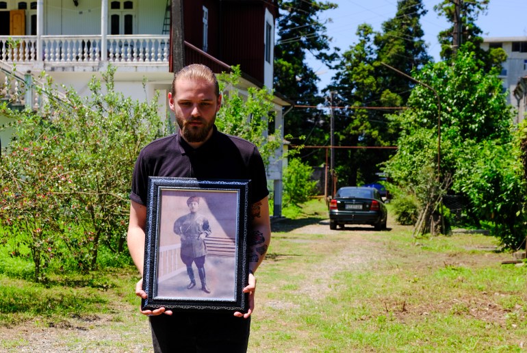 Nika Kuznetsov, Hasan's great-grandson, holds the only photo that the family has of Hasan