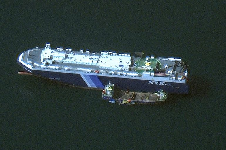 a ship can be seen from above in dark green water