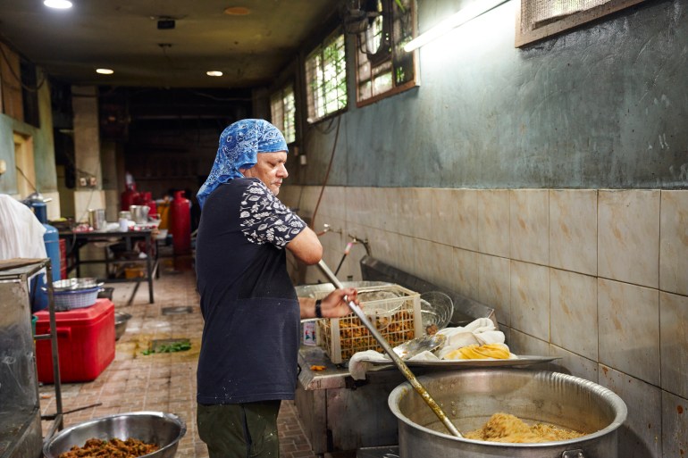 Bikram, who runs the kitchen at the Khalsa Diwan Sikh Temple in Manila, watches over the last batch of food from the morning’s cook. [Sonny Thakur/Al Jazeera]