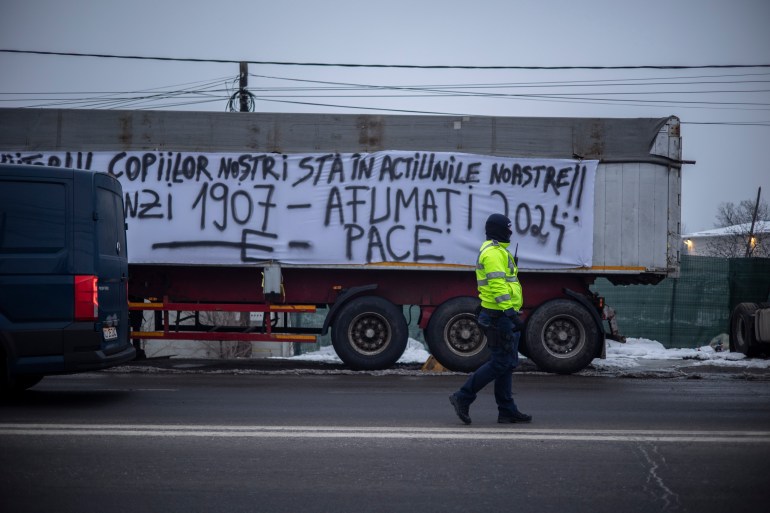"The future of our children lies in our actions!! Flămânzi 1907 – Afumați 2024," reads a large white banner on a truck in Afumati, referencing a historic peasant revolt that took place in Romania a century ago.