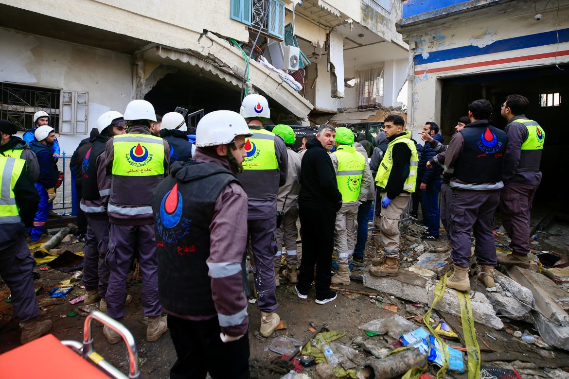 Rescuers work at a damaged buidling following an Israeli military strike in Nabatiyeh