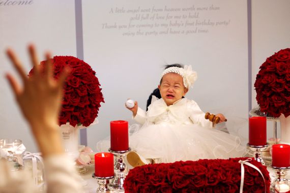 South korean baby in white dress cries at birthday celebration
