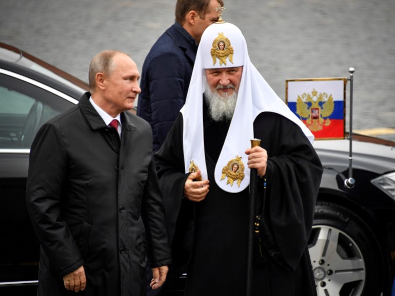 Russian President Vladimir Putin (L) and Patriarch of Russia Kirill arrive to lay flowers at the monument of Minin and Pozharsky on the Red Square near the Kremlin, marking the National Unity Day in Moscow Russia November 4, 2017. REUTERS/Alexander Nemenov/Pool