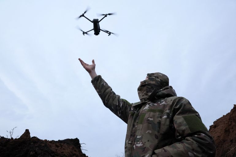 "Soap", 30, a soldier with the 58th Independent Motorized Infantry Brigade of the Ukrainian Army catches a drone while testing it, as Russia's invasion of Ukraine continues, near Bakhmut, Ukraine, November 25, 2022. REUTERS/Leah Millis