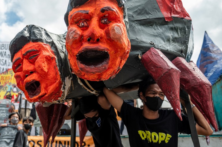 An effigy of Sara Duterte and Ferdinand Marcos Jr made by human rights activists. It is in the form of a spider with red, bulbous, grimacing heads