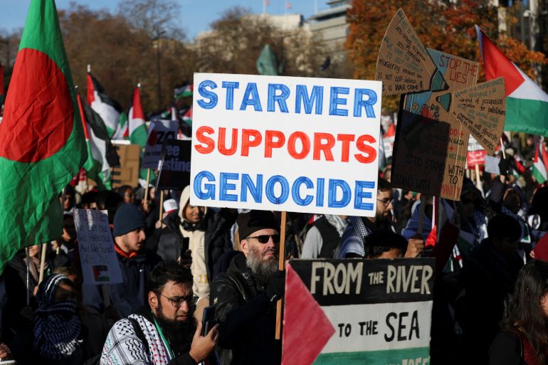 A demonstrator holds a placard referencing Labour Party leader Keir Starmer as people protest in solidarity with Palestinians in Gaza, during a temporary truce between Palestinian Islamist group Hamas and Israel, in London, Britain, November 25, 2023. REUTERS/Hollie Adams
