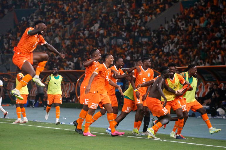 Ivory Coast players celebrate beating Mali