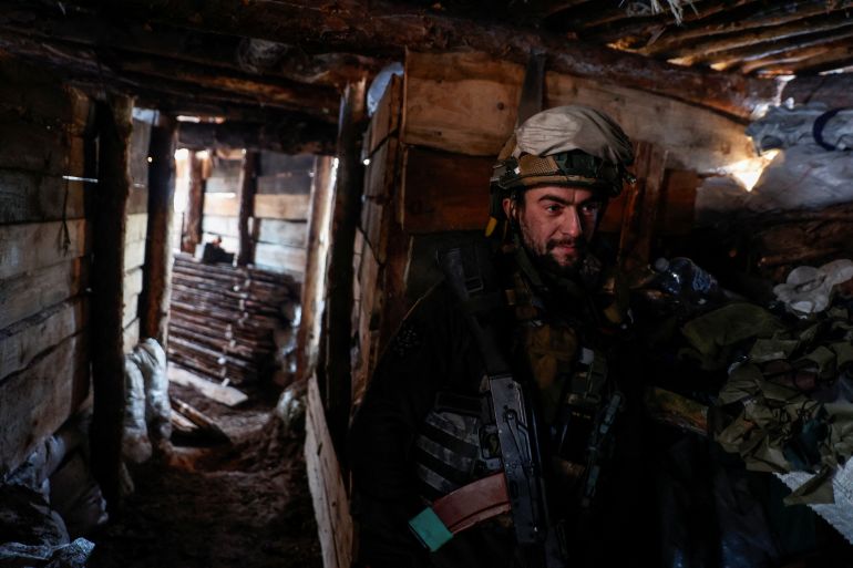 A Ukrainian soldier in a dugout near Kreminna