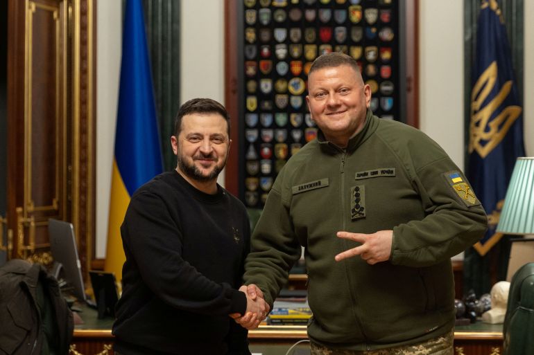 Ukraine's President Volodymyr Zelenskiy and Commander in Chief of the Ukrainian Armed Forces Valerii Zaluzhnyi shake hand and pose for a picture during their meeting