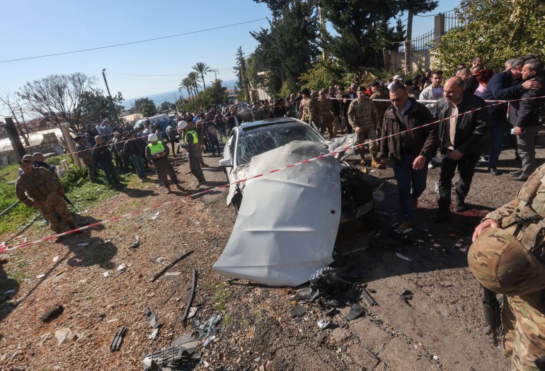 Members of the Lebanese army gather near a destroyed vehicle following what security sources said was an Israeli raid in Jadra, Lebanon on February 10, 2024. Photograph: Aziz Taher - Reuters.