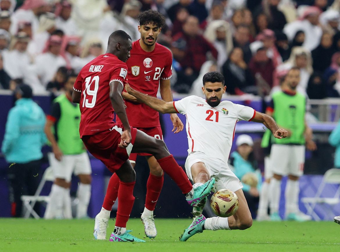 Qatar's Almoez Ali in action with Jordan's Nizar Al Rashdan