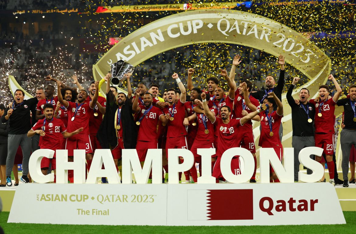 Qatar's Hassan Al-Haydos lifts the trophy with teammates after winning the AFC Asian Cup