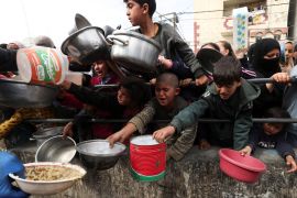 Palestinian children wait to receive food cooked by a charity kitchen amid shortages of food supplies in Rafah, in the southern Gaza Strip on February 13, 2024 [Reuters/Ibraheem Abu Mustafa]