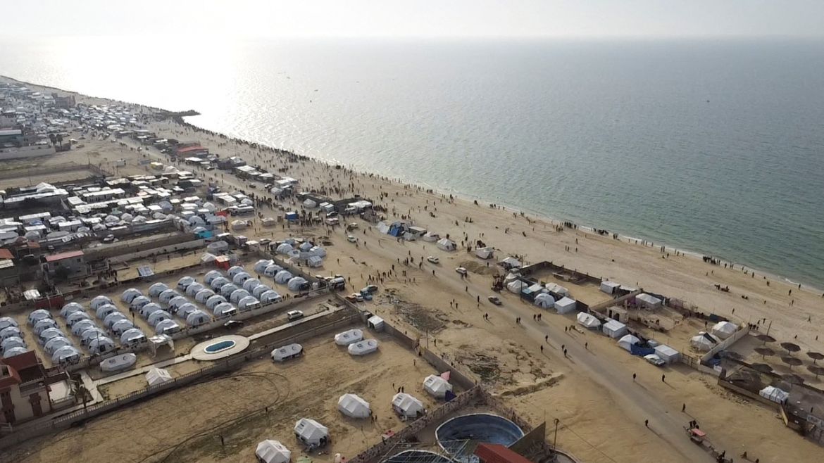 A drone view of Palestinians gathering on a beach