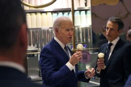 President Joe Biden answers a question from a journalist as he visits an ice cream shop in downtown New York