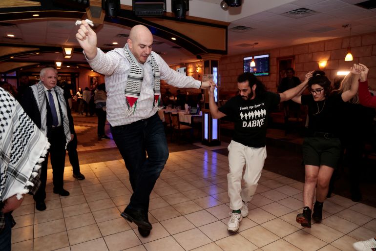 Activist Abbas Alawieh leads the dance Dabke during an uncommitted vote election night gathering as Democrats and Republicans hold their Michigan primary presidential election