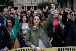Teachers in Athens observe a minute of silence during a 24-hour strike to mark the first anniversary of a train crash that killed 57 people and to demand pay rises. [Louisa Gouliamaki/Reuters]