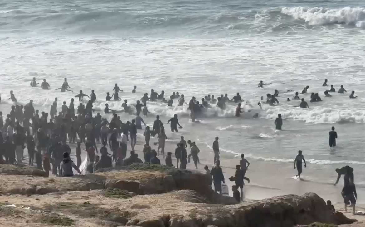 A screen grab captured from a video shows Palestinians waiting for humanitarian aid