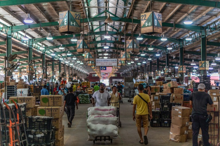 Workers at a wholesale market in Kuala Lumpur