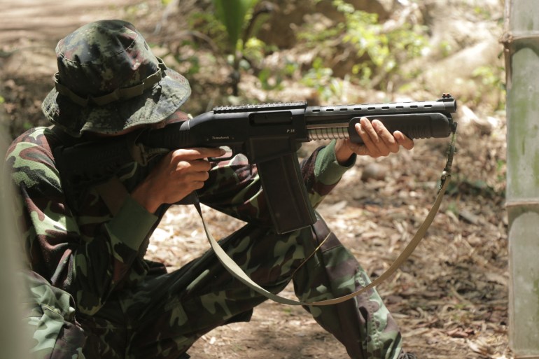 This undated photo taken in May 2021 shows an anti-coup activist undergo basic military training with a weapon at the camp of Karen National Union (KNU), an ethnic rebel group in Karen State after people fled major Myanmar cities due to military crackdown and sought refuge in rebel territories. (Photo by AFP)
