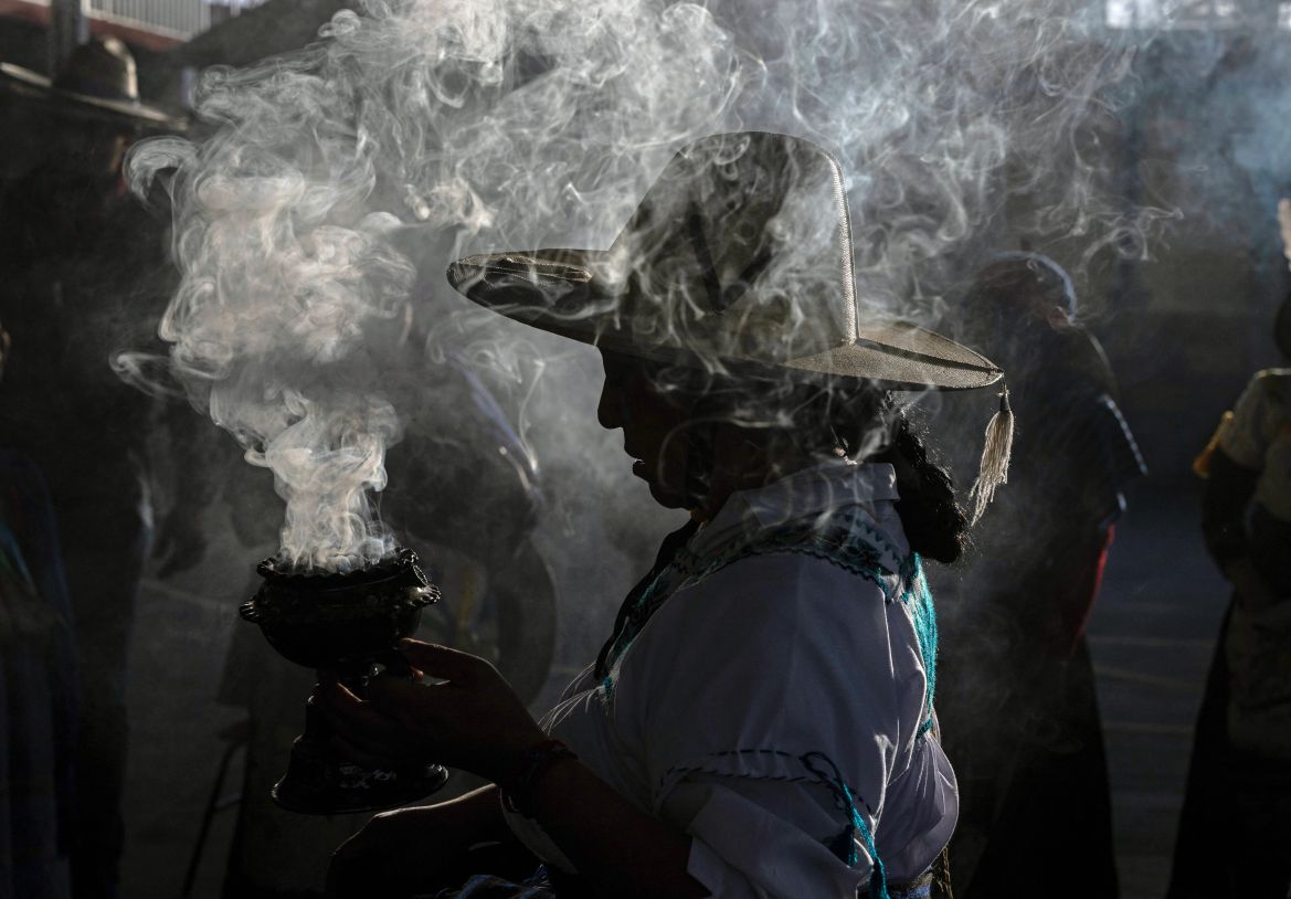 A Purepecha Indigenous woman holds incense during a 3-day ceremonial procession from Cocucho to Ocumicho indigenous villages in Michoacan State, Mexico, on January 31