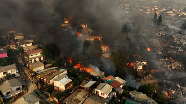 houses can be seen on fire from an aerial view