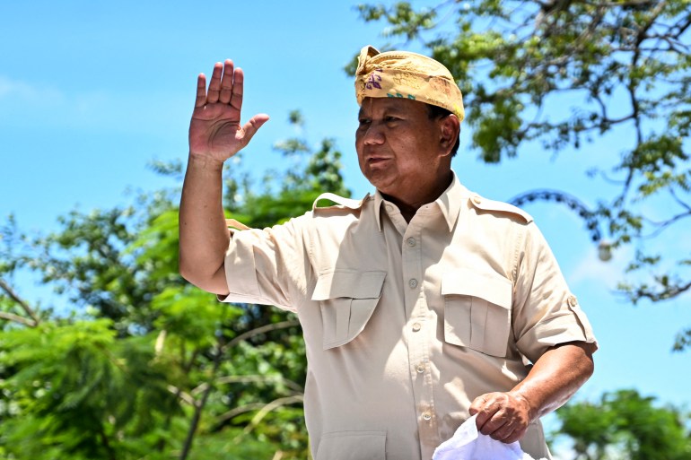 Prabowo Subianto greets supporters as he arrives at a rally in Bali.