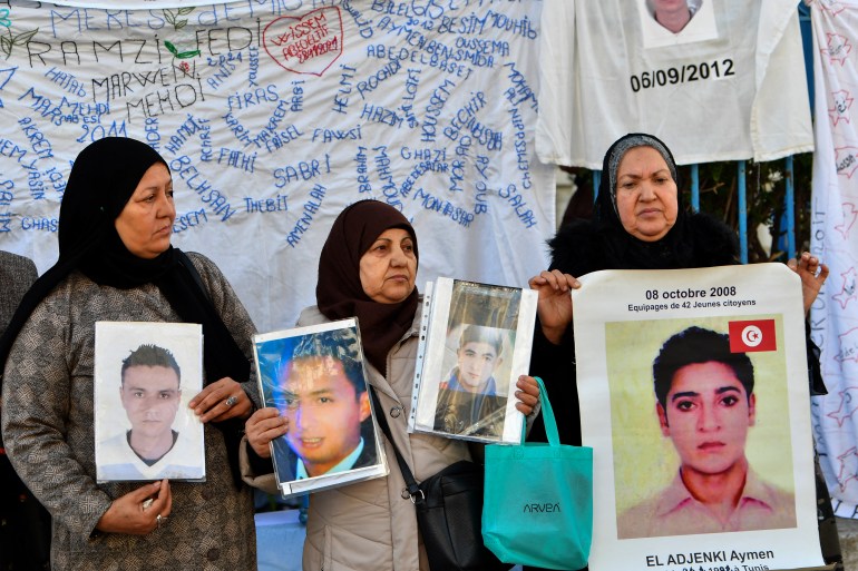 Families of people from al-Hansha in Tunisia's Sfax province who went missing at sea in irregular migration attempts, lift portraits and placards calling on the government to support efforts to find out what happened to their relatives
