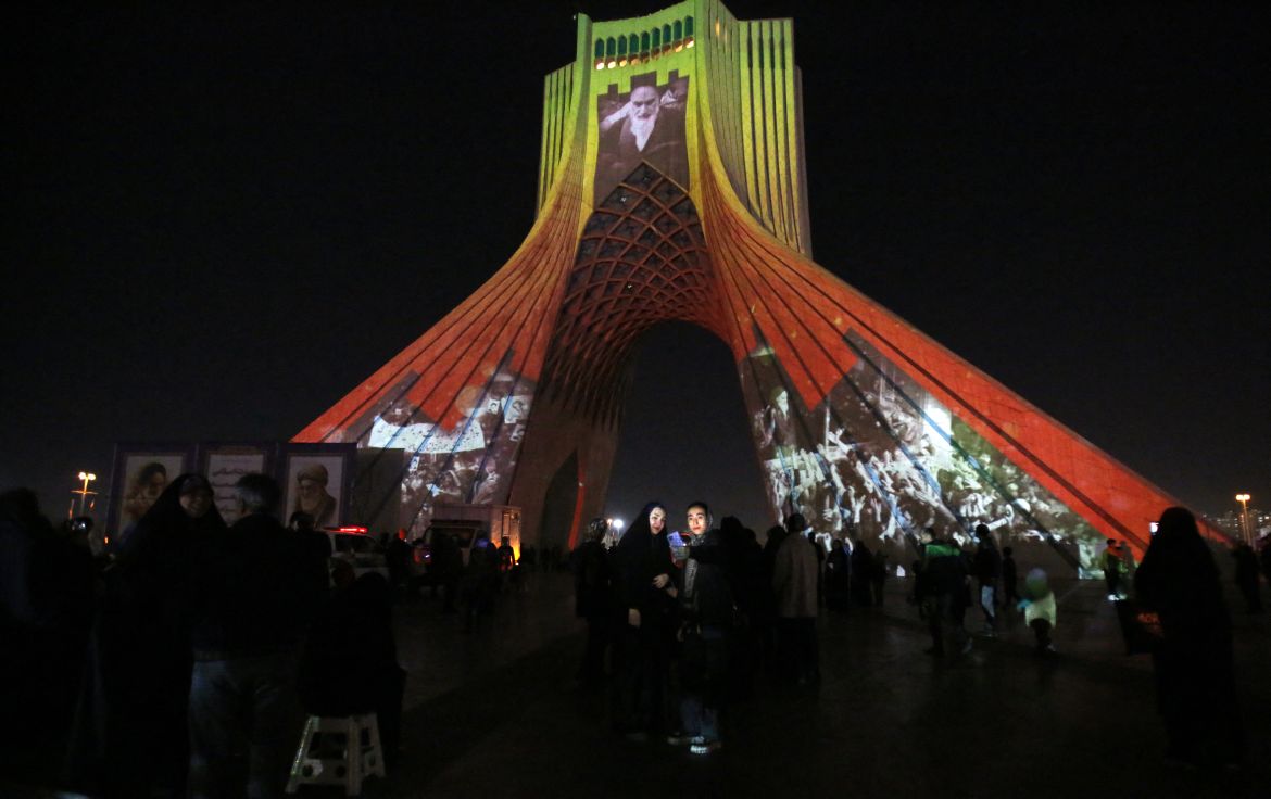 Azadi (Freedom) Tower is illuminated with pictures of Iranian late supreme leader Ayatollah Ruhollah Khomeini and Iran's national flag during a ceremony of the 45th anniversary of the Islamic Revolution