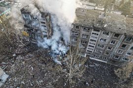 This photograph released by National Police of Ukraine on February 14, 2024, shows rescuers extinguish a fire in a residential building following a Russian missile attack in Selydove, Donetsk region, Ukraine [Handout via AFP]
