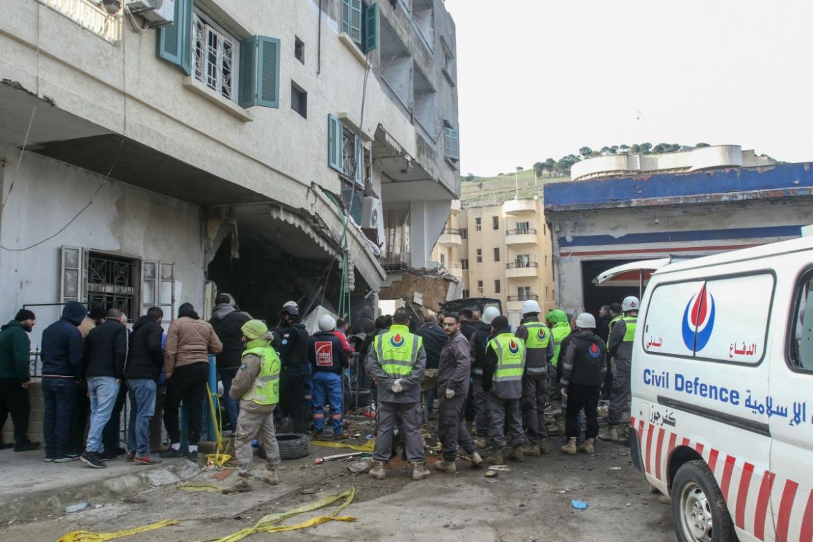 Rescuers work at a damaged buidling following an Israeli military strike in Nabatiyeh