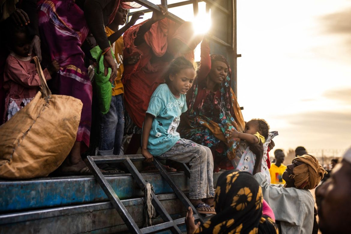 A Sudanese girl who has fled from the war in Sudan with her family reacts while getting off a truck loaded with Sudanese families arriving at a Transit Centre for refugees in Renk