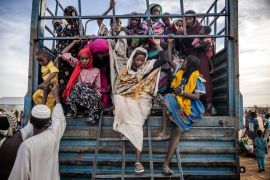 Sudanese refugees who have fled from the war in Sudan get off a truck loaded with families arriving at a Transit Centre for refugees in Renk, on February 13, 2024 [Luis Tato/AFP]