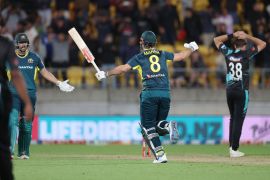 Mitchell Marsh celebrates with teammate Tim David after Australia won the first T20 match against New Zealand at Sky Stadium in Wellington [Marty Melville/AFP]