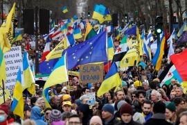 In Paris, people wave European and Ukrainian flags during a rally commemorating the second anniversary of Russia&#039;s invasion of Ukraine [Geoffroy Van Der Hasselt/AFP]