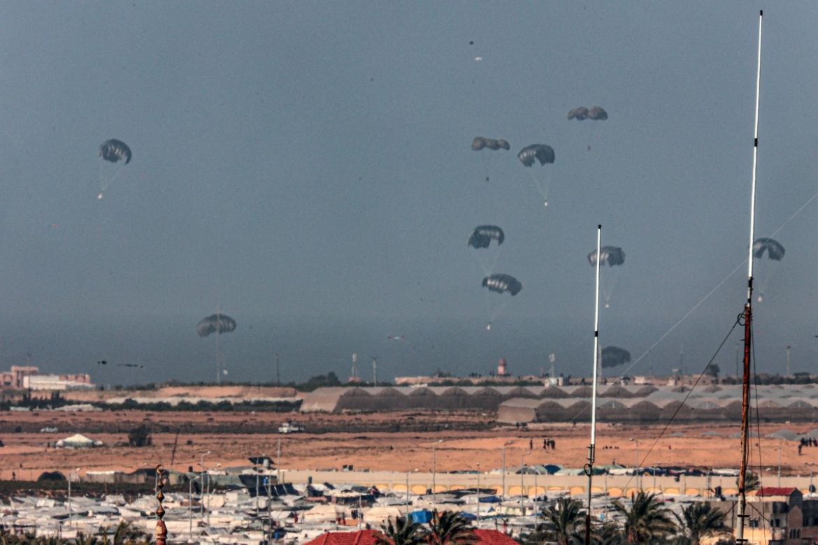 A Jordanian military aircraft (not pictured) drops humanitarian aid over Rafah a