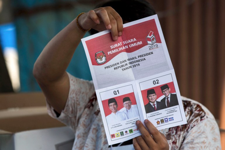 A ballot paper from 2019 showing a hole in Jokowi's box to indicate a vote for him.