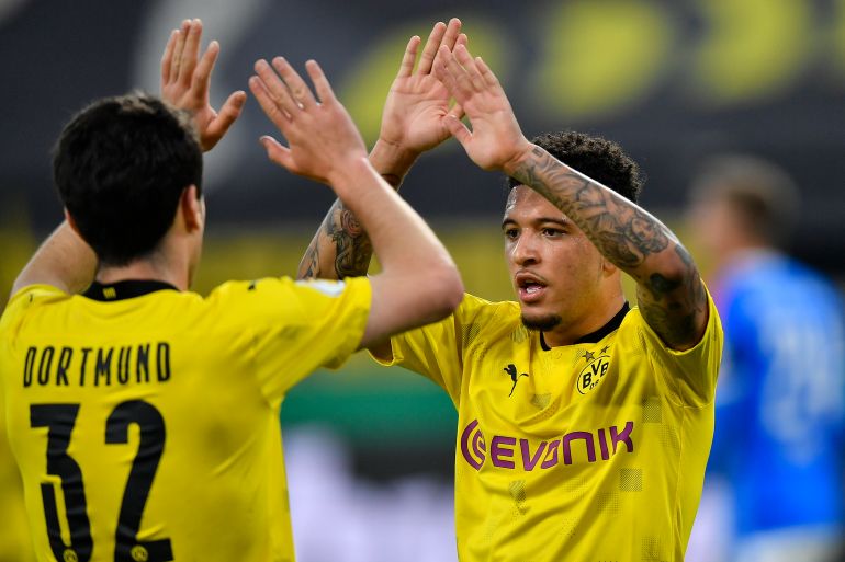FILE - Dortmund's Jadon Sancho celebrates after scoring the opening goal during the German Soccer Cup semifinal match between Borussia Dortmund and Holstein Kiel in Dortmund, Germany, Saturday, May 1, 2021. Jadon Sancho has returned to his old club Borussia Dortmund on loan for the rest of the season after being frozen out of the Manchester United squad. The deal does not come with an option for Dortmund to buy Sancho. (AP Photo/Martin Meissner, Pool, File)