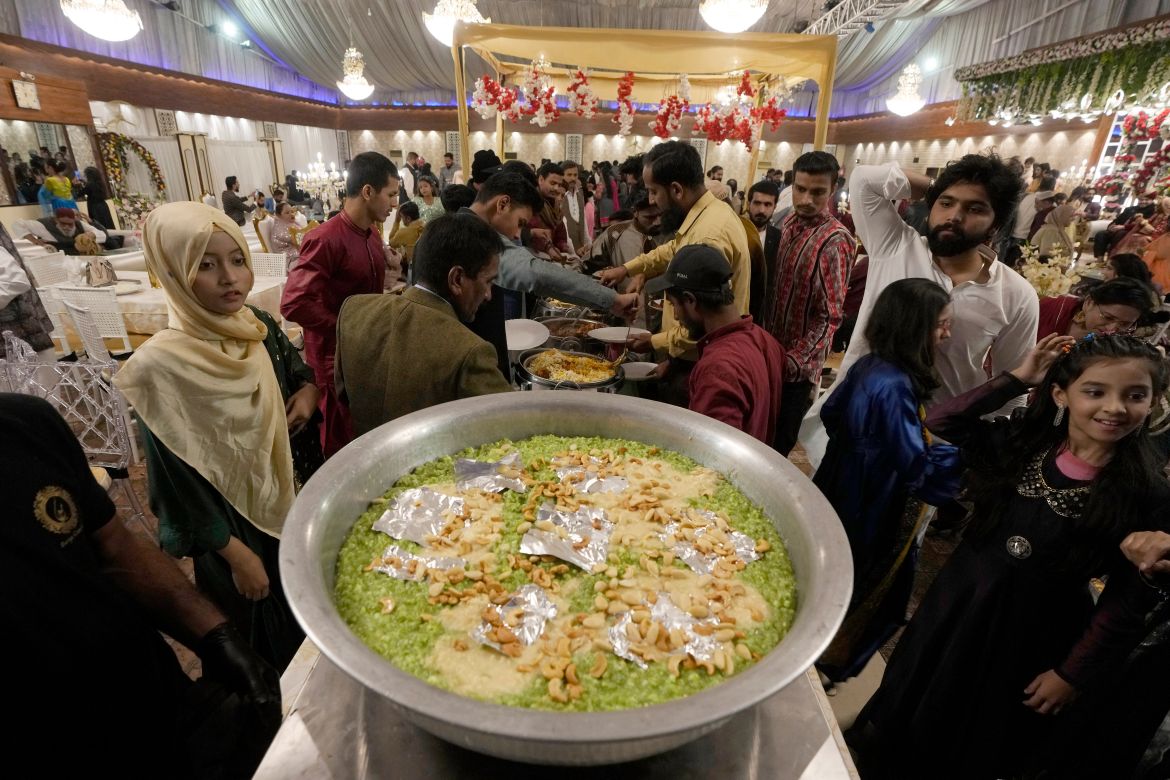 Guests take meal during a wedding ceremony at Radiance banqueting hall, in Karachi, Pakistan