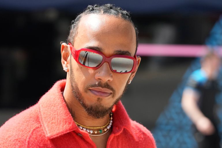 FILE - Mercedes driver Lewis Hamilton of Britain arrives at the Bahrain International Circuit in Sakhir, Bahrain, Thursday, March 2, 2023. Seven-time Formula One champion Lewis Hamilton has been linked with a shock move from Mercedes to Ferrari next year. (AP Photo/Frank Augstein, File)