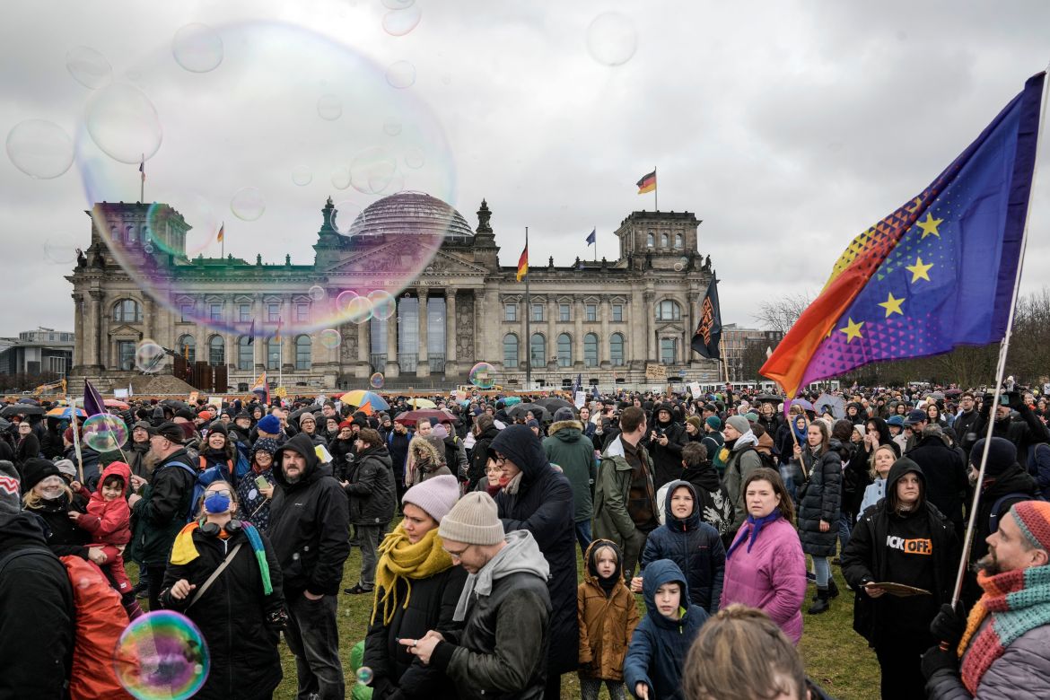 People protest with soap bubbles in front of Germany's parliament Reichstag at a demonstration against the AfD party and right-wing extremism in Berlin, Germany, Saturday, Feb. 3
