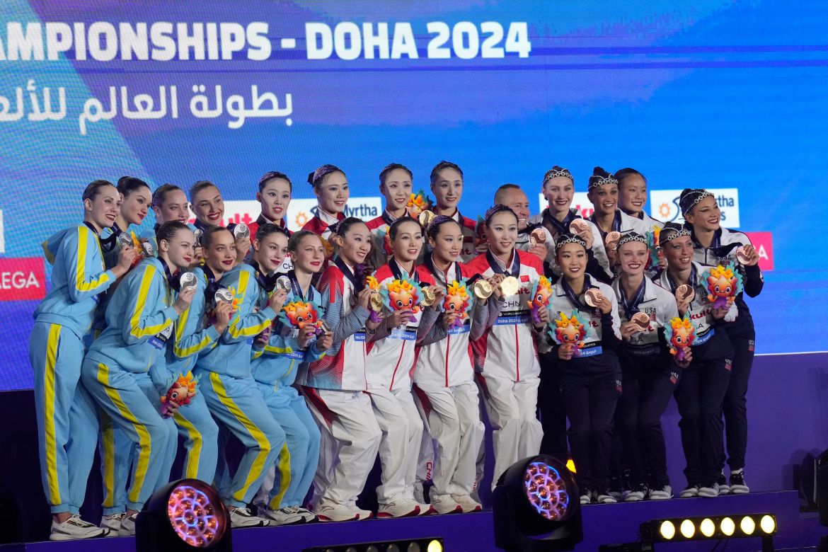 Gold medalists China team, center, silver medalists Ukraine team, left, bronze medalists United States team, right, pose with their medals during the medal ceremony for the mixed team acrobatic final of artistic swimming at the World Aquatics Championships in Doha, Qatar, Sunday, Feb. 4